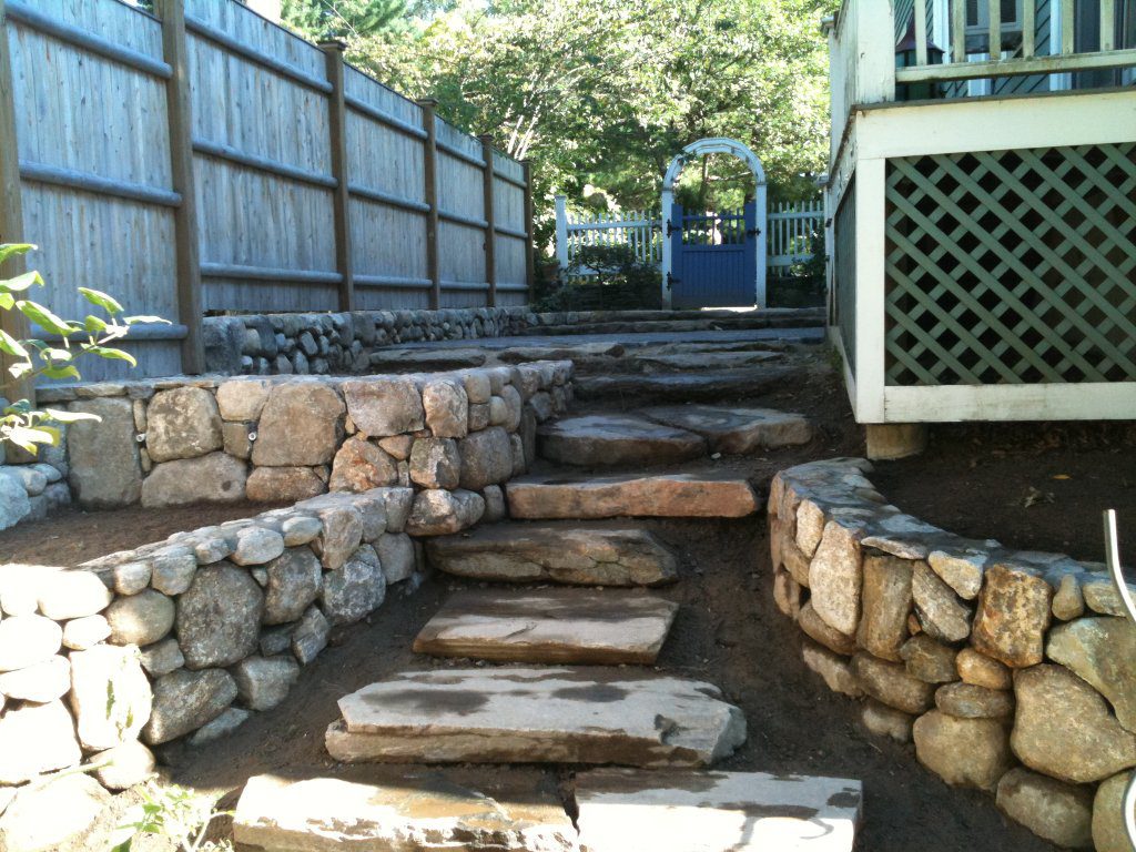 Large stone steps leading to patio seating area